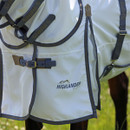Close-up of Highlander Plus logo and front fastening buckles on a white fly rug.
