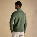 Rear view of the model wearing the green quarter-zip fleece, showing the fit and plain back design.