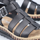 Close-up of the black leather-look straps and silver buckle on the platform sandal, showing the stitched detailing and textured upper.