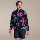 Model wearing navy fleece jacket with colourful floral texture, front view on studio background