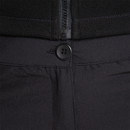 Close-up of black outdoor trousers waistband showing button fastening and zip fly detail.