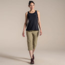 Full-body studio shot of woman wearing khaki cropped trousers with black sleeveless top and hiking shoes.