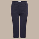 Flat lay front view of navy women’s 3/4 length walking trousers on beige background.