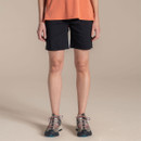 Front view of black women’s walking shorts worn with hiking shoes on plain studio background.