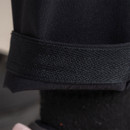 Close-up of textured internal waist grip on black trousers.