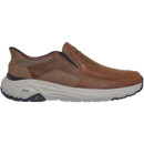 Brown leather slip-on shoe with cushioned white arch-fit sole, featuring subtle stitching and elastic side panels for comfort and a casual look.