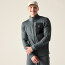 Model wearing grey full-zip midlayer jacket with high collar and contrast chest panel, smiling, with cap
