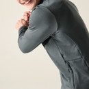 Close-up of grey midlayer jacket back and sleeve showing seam detailing and textured fabric.