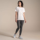 Full-body studio shot of model wearing an off-white Craghoppers x National Trust T-shirt with grey leggings and trainers.