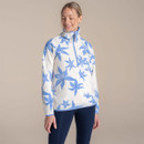 Woman wearing an off-white half-zip fleece with bold blue floral print and high collar, studio background.