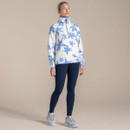 Full-length studio photo of a woman in an off-white blue floral half-zip fleece with high collar and long sleeves.