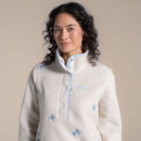 Close-up of the collar and popper placket on an off-white sherpa fleece with pale blue trim and scattered blue embroidery.