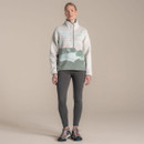 Full-length view of women’s sherpa fleece half-snap top in cream with sage green printed lower panel, styled with grey leggings and hiking shoes.