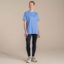 Full-length studio shot of model wearing a light blue Craghoppers T-shirt with small chest logo print and dark leggings.