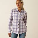 Three-quarter front view of the model wearing the purple-and-white plaid button-up shirt with sleeves down.
