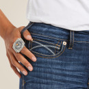 Close-up of the front pocket with contrast stitching and a silver statement ring on the model’s hand.