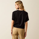 Back view of the black short-sleeve tee paired with tan pants, showing the plain back of the shirt.