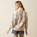 Back view of the oatmeal half-zip pullover showing the allover blue geometric print, paired with distressed denim shorts.