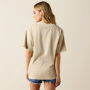 Back view of beige oversized T-shirt on model with distressed denim shorts; plain back with crew neckline.