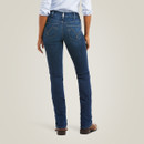 Back view of the model wearing dark-wash straight-leg jeans and brown boots, showing the yoke and back pocket stitching.