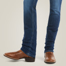 Close-up of dark-wash straight-leg jeans stacked slightly at the ankle over brown leather western boots.