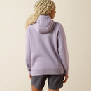 Back view of the lavender hoodie showing the hood and relaxed fit over grey shorts.