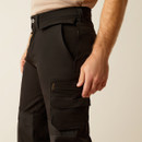 Side close-up of the pants showing the waist, hip, and a stacked thigh pocket/utility pocket detail in black fabric