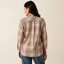 Back view of a woman wearing the beige-and-pink plaid button-up shirt with long sleeves, shown against a light studio background.