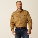 Male model wearing a khaki long-sleeve button-down work shirt with two chest flap pockets, styled with dark jeans and a brown belt against a neutral studio background.