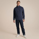 Full-length studio shot of a male model wearing a navy half-zip fleece with jeans and white trainers.
