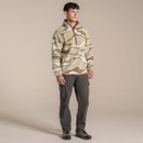Full-length studio shot of a male model wearing the patterned half-zip fleece with cargo trousers and hiking shoes.