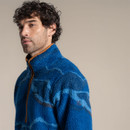 Close-up of a male model wearing the blue patterned fleece, showing the high collar, zip and textured fabric.