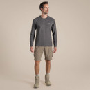 Full-length view of a male model wearing pebble-coloured NosiLife cargo shorts with a long-sleeve top and walking boots.