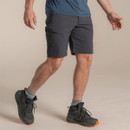 Side view of the model walking in dark lead shorts with hiking boots.