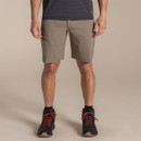 Front view of the model wearing pebble walking shorts with hiking boots.