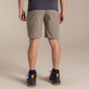 Back view of the model wearing the pebble shorts with hiking boots.