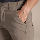Close-up of the zipped hand pocket on the pebble shorts, with the model’s hand inside.
