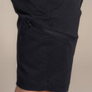 Close-up of the zipped thigh pocket on the black shorts.