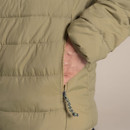Close-up of the zipped hand pocket on the cardamom jacket, with the model’s hand inside.