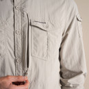 Close-up of the parchment shirt front, showing the chest pocket and concealed zip detail.