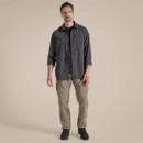 Full-length view of the model wearing the black pepper long-sleeved adventure shirt with sleeves rolled up, paired with khaki cargo trousers and walking boots.