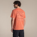 Model wearing orange Craghoppers T-shirt, back view showing large tonal graphic print.