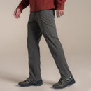 Side view of the model wearing the dark khaki trousers with walking shoes.