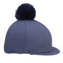 Navy Aubrion riding hat silk with faux fur pom pom, side view showing peak and elasticated edge on white background.