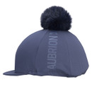 Aubrion navy riding hat silk with faux fur pom pom and peak, three-quarter side view on white background.