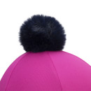 Close-up of black faux-fur pom pom on a bright pink Aubrion riding hat cover, showing textured fabric panels.