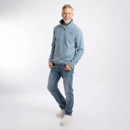 Full-length view of model wearing the light blue quarter-zip textured fleece with blue jeans and white trainers.