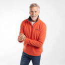 Model wearing a spice-orange gridfleece quarter-zip pullover with arms crossed, paired with jeans.