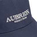 Close-up of navy Aubrion Equestrian cap showing white embroidered logo on the front panel and peak.