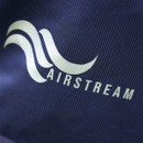 Close-up of the Airstream logo printed on textured navy fabric on a horse rug.